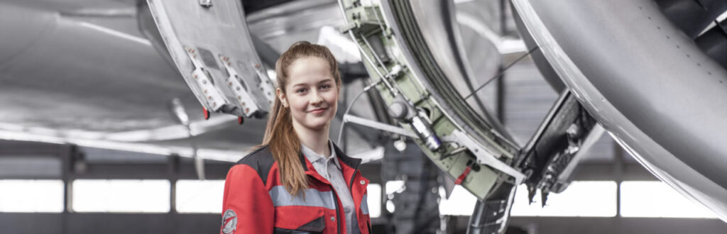 Woman standing in front of an airplane